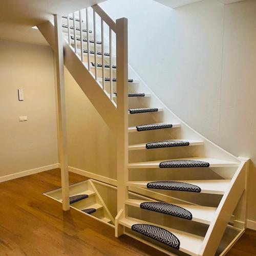 a staircase with wine shelves under the stairs at Tante Ursula B&B in Venlo