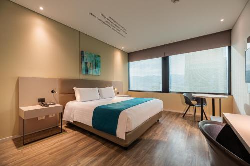 Postel nebo postele na pokoji v ubytování Hotel Estelar Square