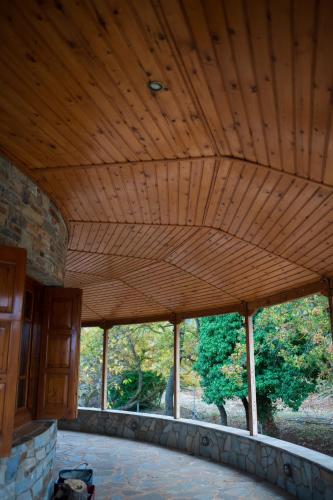 a large wooden ceiling in a room with windows at Vila Elati Oreini Korinthia in Velína