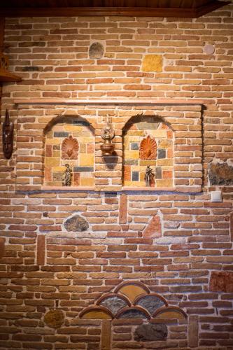 a brick wall with two windows on it at Vila Elati Oreini Korinthia in Velína