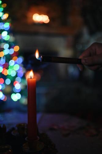 a person is lighting a cigarette next to a candle at Vila Elati Oreini Korinthia in Velína
