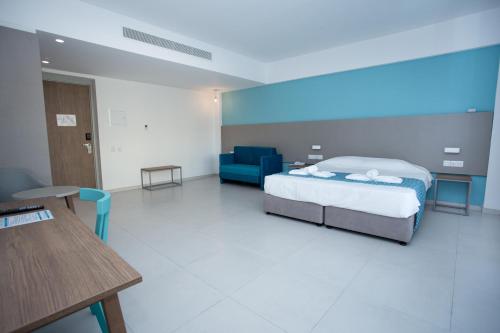 a bedroom with a bed and a couch and a table at Mandali Hotel in Protaras