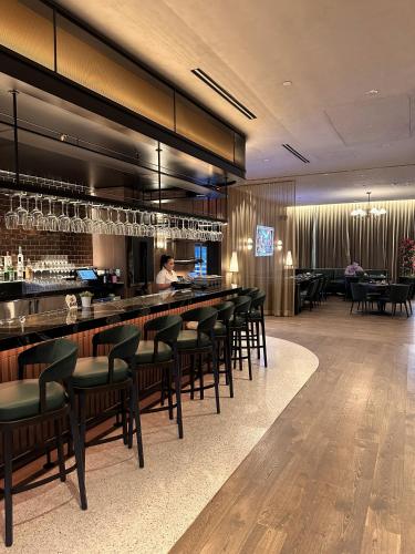 a restaurant with a bar with chairs and a waitress at Wonderful 1 Bed - Amazing views in Miami