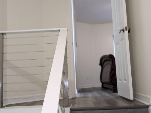 a sliding glass door in a room with a chair at Oceanfront 2br2b, Ocean Views, Heated Pool, Spa in Cape Canaveral