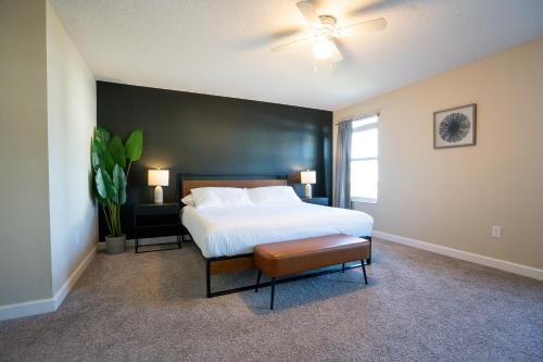 a bedroom with a bed and a black wall at Storey Lake Pool Home with Resort Amenities near DISNEY in Kissimmee