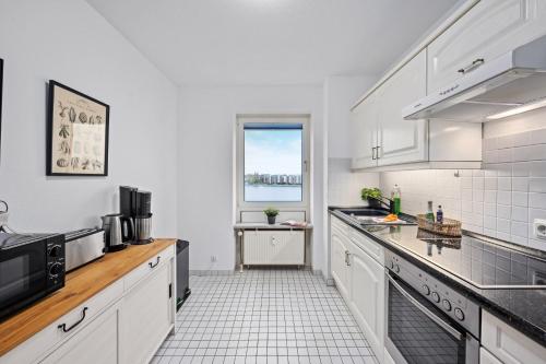 a kitchen with white appliances and a window at Strand-Apartment, Strandkorb, Meeresrauschen, Parkplatz in Wilhelmshaven