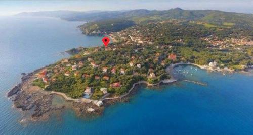 a red balloon flying over an island in the water at Appartamenti Torre Medicea in Castiglioncello