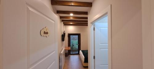 a hallway with a white door leading into a room at Xanela Xures in Muiños