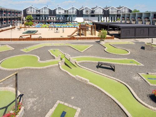 a park with a playground and a building at 6 person holiday home in Glesborg in Glesborg
