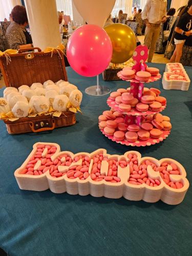 a table topped with plates of cookies and balloons at Hotel Villa Camilla in Varazze