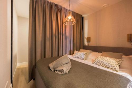 a bedroom with a large bed with pillows on it at Haya Seaview - The Casino in Scheveningen