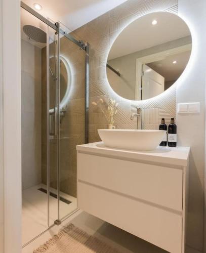 a bathroom with a sink and a mirror at Haya Seaview - The Casino in Scheveningen