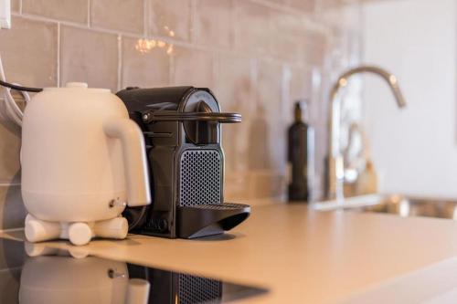 a coffee maker sitting on a counter in a kitchen at Haya Seaview - The Casino in Scheveningen