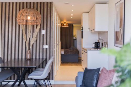 a dining room and kitchen with a table and chairs at Haya Seaview - The Casino in Scheveningen