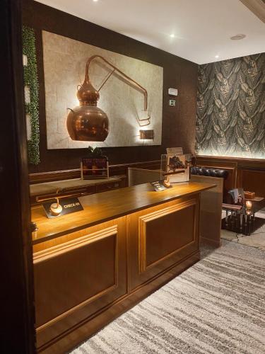 a lobby with a desk with a light on it at Hotel Lusitano in Vilar Formoso