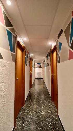a corridor in an office building with colorful walls at Hotel Villa Camilla in Varazze