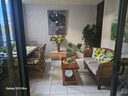 a living room with a couch and a table at Jackies City Central Apartment in Cairns