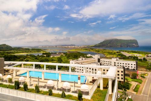 an aerial view of a hotel with a view of the ocean at The Best Jeju Seongsan in Seogwipo