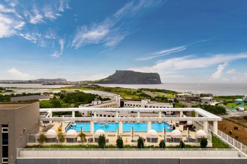 an aerial view of a resort with a pool at The Best Jeju Seongsan in Seogwipo