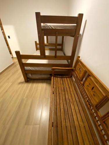 a wooden chair sitting on top of a wooden floor at Village Martin de Sá in Caraguatatuba