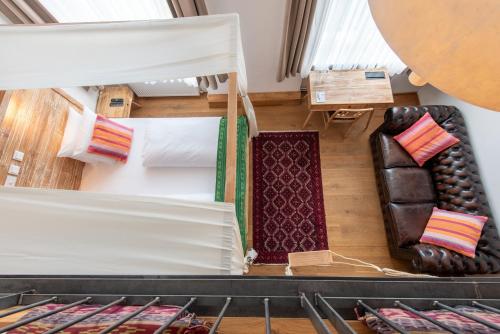 an overhead view of a room with a bed and chairs at Lulu Guldsmeden in Berlin
