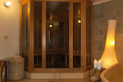 a large wooden cabinet in a bathroom with candles at Oslo Guldsmeden in Oslo