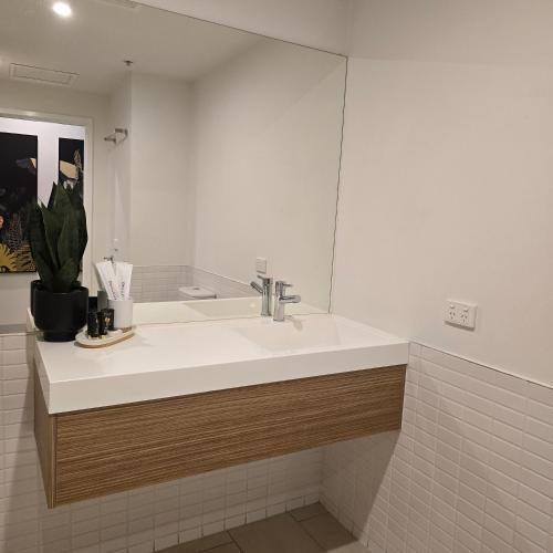 a bathroom with a sink and a mirror at Pristine on Flinders in Melbourne