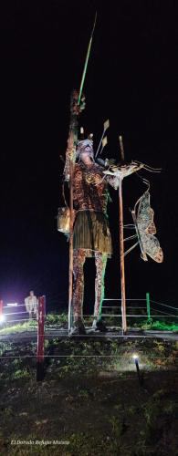 a statue of a man with a spear on a stand at El Dorado Refugio Muisca in Guatavita