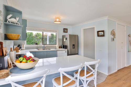 a kitchen with a bowl of fruit on a table at Callala Bay Gem - Jervis Bay - Pet Friendly Getaway with Spa in Callala Bay