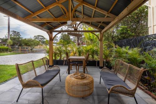 a pergola with two chairs and a table at Callala Bay Gem - Jervis Bay - Pet Friendly Getaway with Spa in Callala Bay