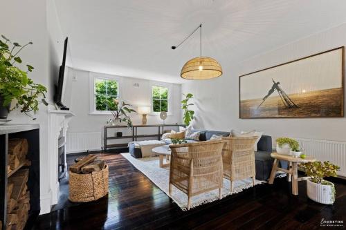 a living room with a couch and a fireplace at The Waratah House -Indoor Sauna & Outdoor Firepit and walking distance to Town center in Katoomba