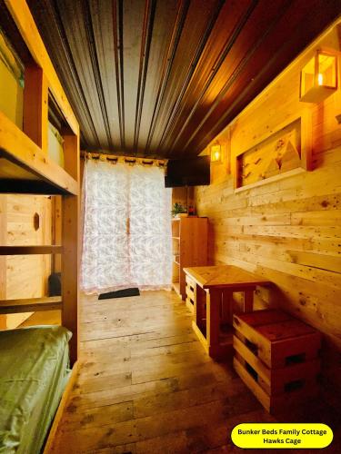 a room with a desk and a window in a cabin at Hunters Wood Cabins in Nuwara Eliya