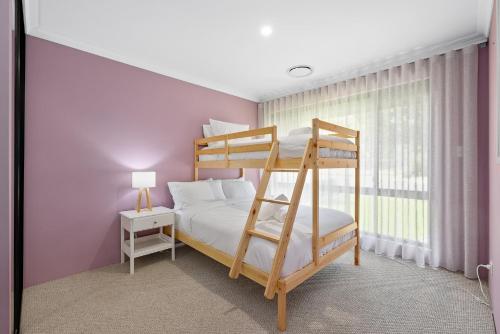 a bedroom with a bunk bed and a window at Family Friendly Close 2 Airport, Optus, Crown & City in Perth
