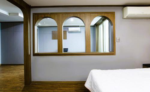 a bedroom with a mirror and a bed in it at Zenith Hotel in Guri