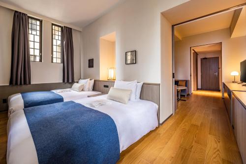 Ένα ή περισσότερα κρεβάτια σε δωμάτιο στο The Gate Hotel Kyoto Takasegawa by Hulic