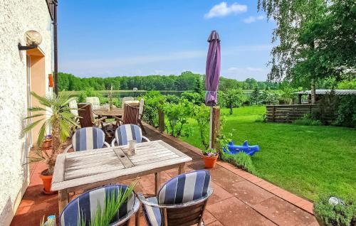 a patio with a table and chairs and an umbrella at Wohnung Templin Ot Dargersdorf in Dargersdorf