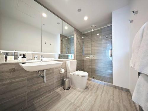 a bathroom with a sink and a toilet and a shower at Hereford aparment in Auckland