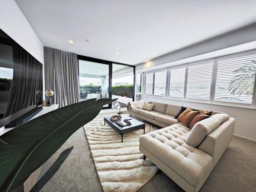 a living room with a couch and a table at Hereford aparment in Auckland