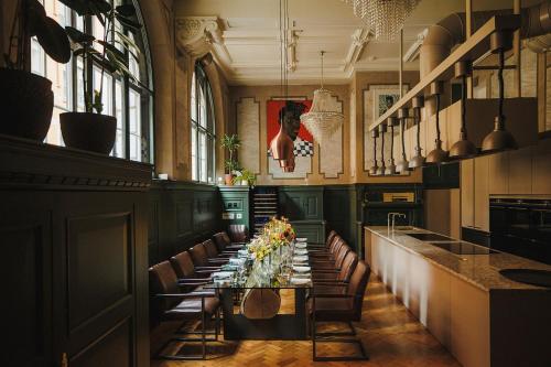 a long dining room with a long table and chairs at Stock Exchange Hotel, Manchester, Autograph Collection in Manchester