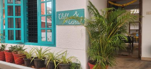a group of potted plants in front of a building at Cliff and Coral Varkala, North Cliff in Varkala