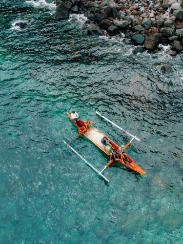 a boat sitting in the water in the ocean at Bintana Sa Paraiso in Mambajao
