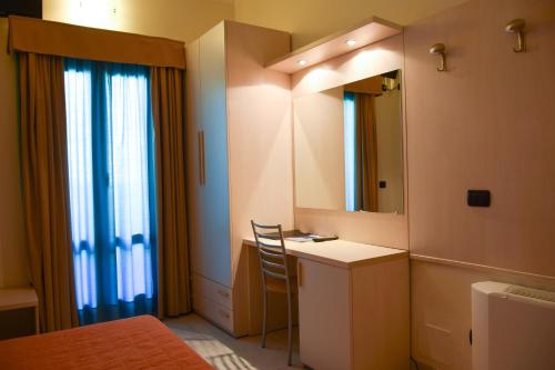 bagno con lavabo e mobile con lavabo e specchio. di Hotel Losanna a Milano
