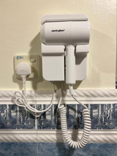 a phone on a wall in a bathroom at HOTEL SRI SUTRA (BANDAR SUNWAY) in Petaling Jaya