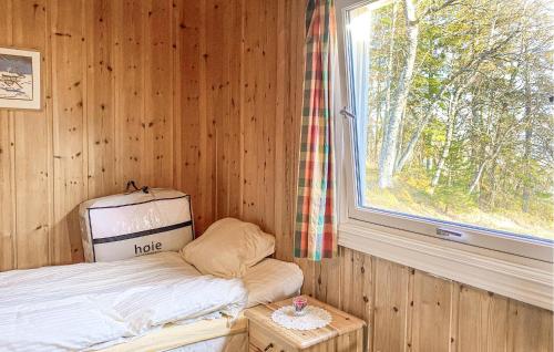a small room with a bed and a window at 4 Bedroom Awesome Home In Fosslandsosen in Fosslandsosen