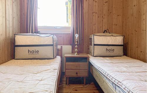 two beds with boxes on them in a room at 4 Bedroom Awesome Home In Fosslandsosen in Fosslandsosen