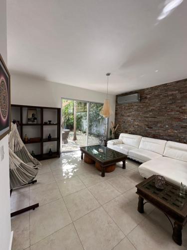 a living room with a couch and a table at Zen Home in Tulum