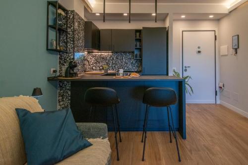 a kitchen with a blue island in a living room at HOLIDAYS HOMES ROME GOLF Appartamenti Marco Simone AeB in Marco Simone