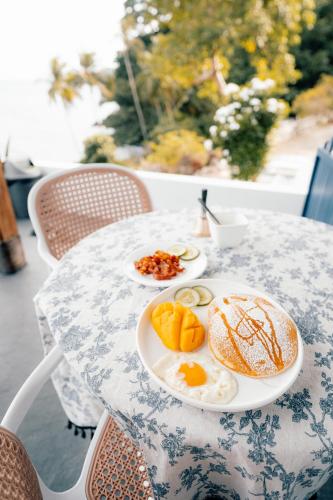 a table with two plates of food on it at Bintana Sa Paraiso in Mambajao