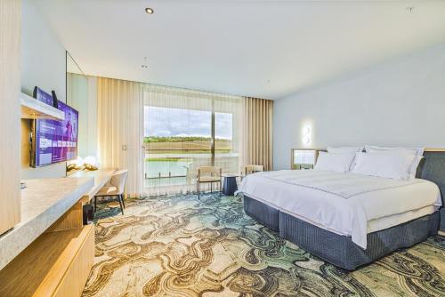 a hotel room with a bed and a television at Re’em Yarra Valley in Gruyere