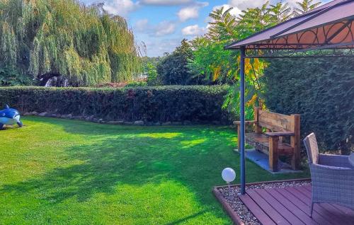 a garden with a bench and a gazebo at Ferienhaus Dabel in Dabel
